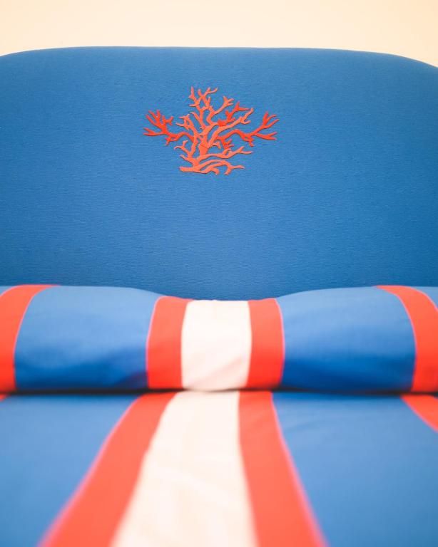 a blue and red surfboard with a red coral on it at Parco Augusto in Capri