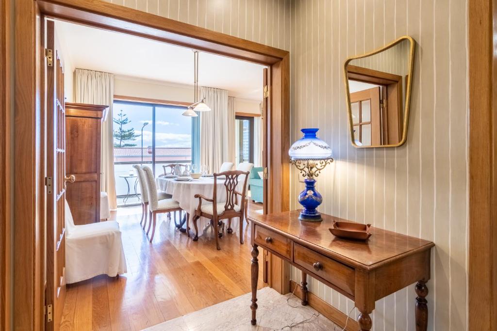 a dining room with a table and a mirror at Suite 106 - Two bedroom apartment in Funchal