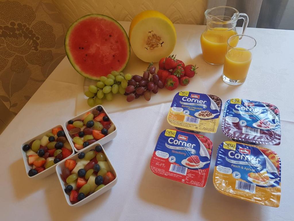 a table with fruit and juice and snacks on it at Bay Lodge in Penzance