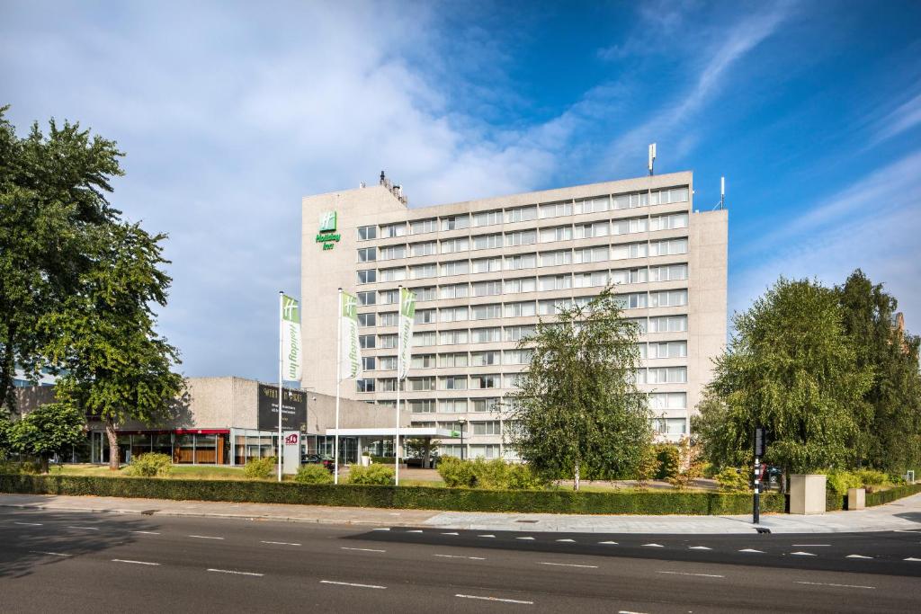 a large building with a large clock on the side of it at Holiday Inn Eindhoven Centre, an IHG Hotel in Eindhoven