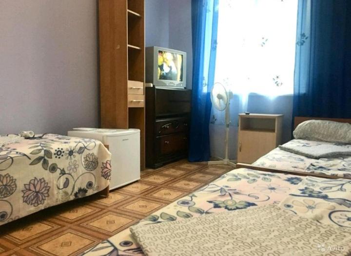 A bed or beds in a room at Гостевой дом ОК