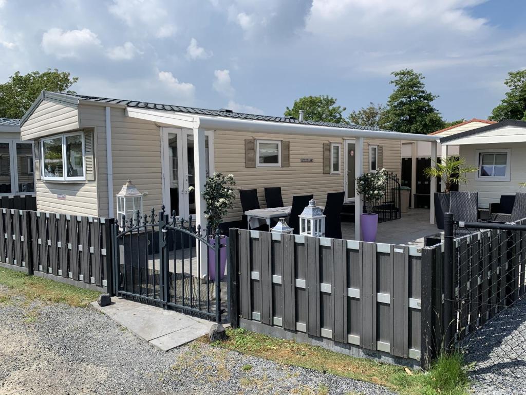 une clôture en bois devant une maison dans l'établissement RBR 662 - Beach Resort Kamperland, à Kamperland