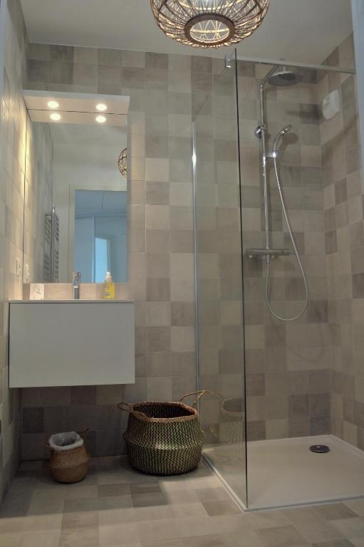 a bathroom with a glass shower and a sink at Arbre Blanc, une folie montpelliéraine in Montpellier