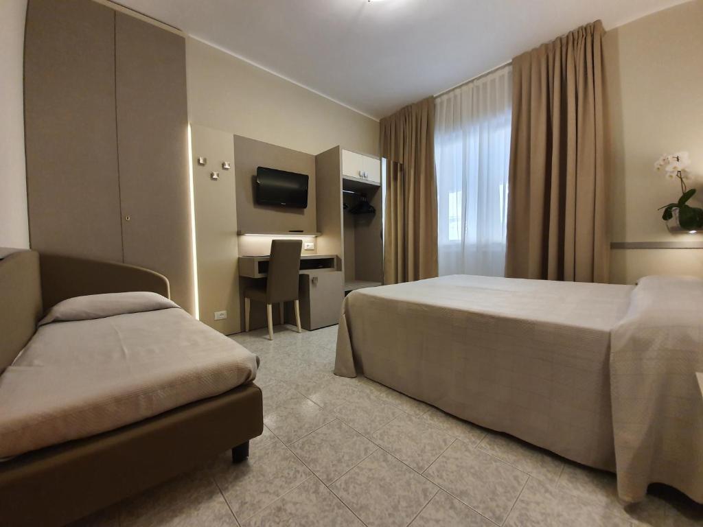 Postel nebo postele na pokoji v ubytování Hotel Corallo