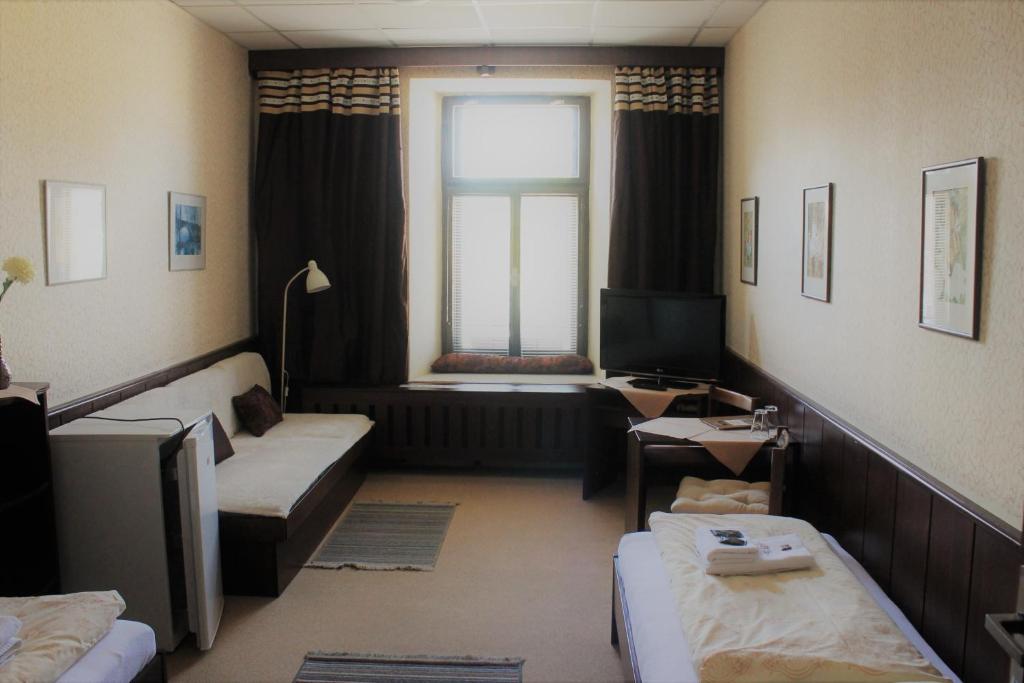 Łóżko lub łóżka w pokoju w obiekcie Hotel Panský Dům Žamberk