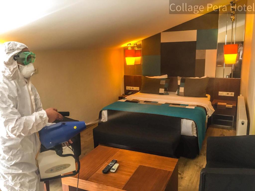 a person in a room with a bed at Collage Pera Hotel in Istanbul