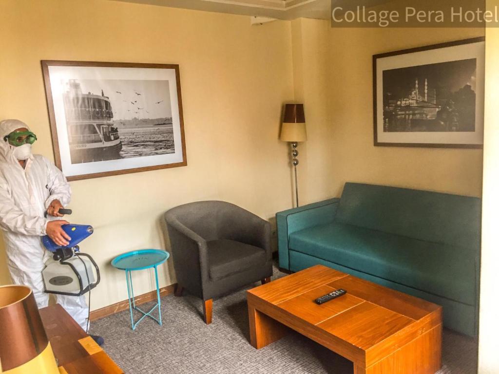 a man wearing a mask in a living room with a couch at Collage Pera Hotel in Istanbul