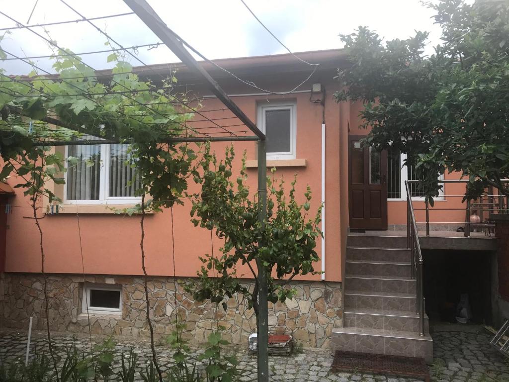 a house with a staircase in front of it at Tainov House in Samokov