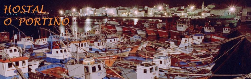 a bunch of boats docked in a harbor at night at Hostal O Portiño in Rianjo