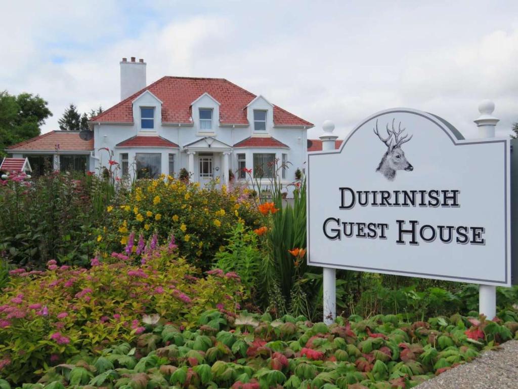 a guest house sign in front of a guest house at Duirinish Guest House in Portree