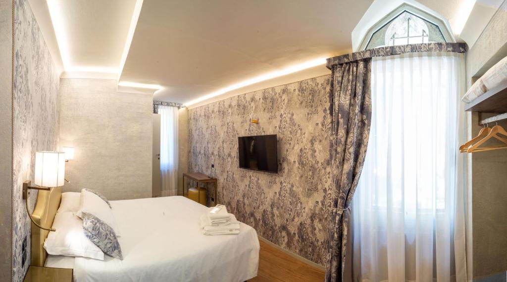 Postel nebo postele na pokoji v ubytování Locanda Cavanella