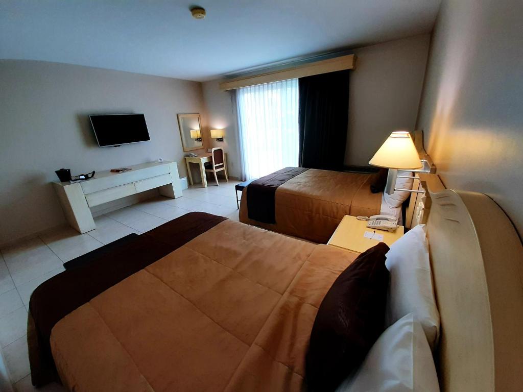 Postel nebo postele na pokoji v ubytování Hotel Real de Minas Bajio