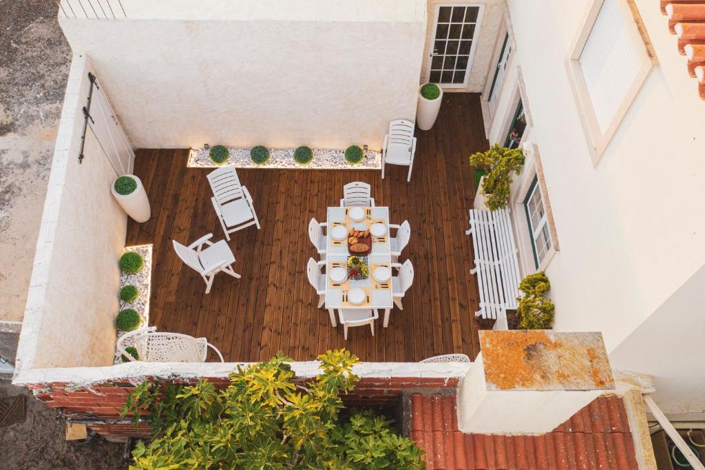 an overhead view of a patio with a table and chairs at Best Houses 41 - The Best Beach House in Peniche in Ferrel