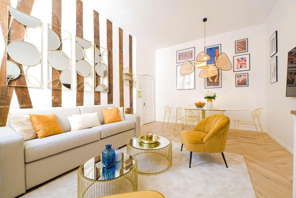 a living room with a white couch and a table at Luxury home in PARIS - Musée du Louvre in Paris