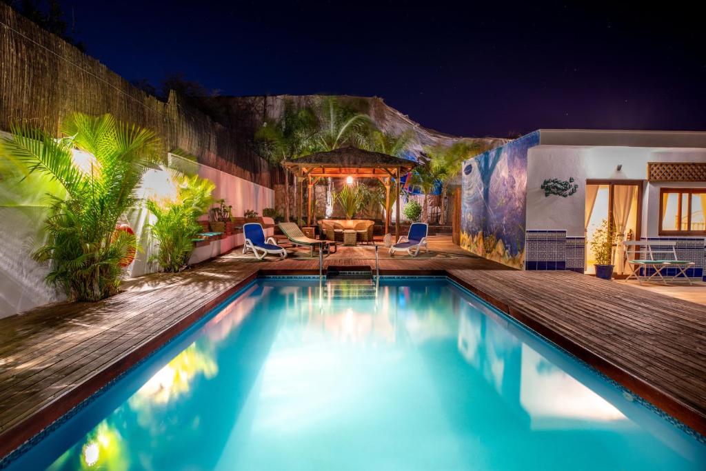 a swimming pool in a backyard at night at Villa La Perla in Candelaria