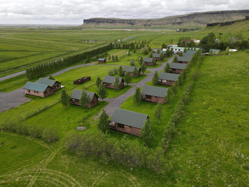 an aerial view of a farm with houses and a road at Hörgsland Cottages in Hörgsland
