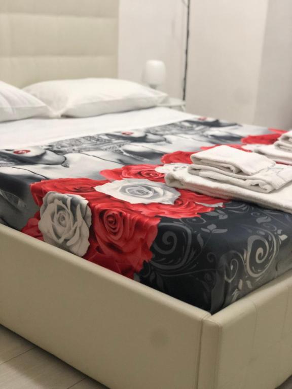 a bed with clothes stacked on top of it at Al Porto in Gaeta