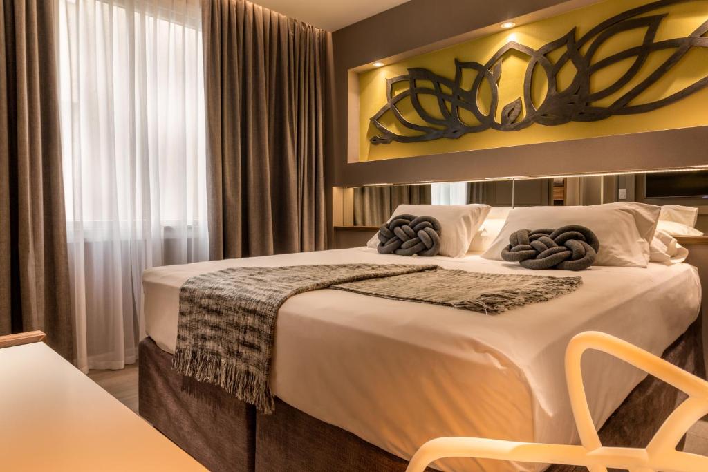 a bedroom with a large bed with towels on it at Up Congreso Hotel in Buenos Aires