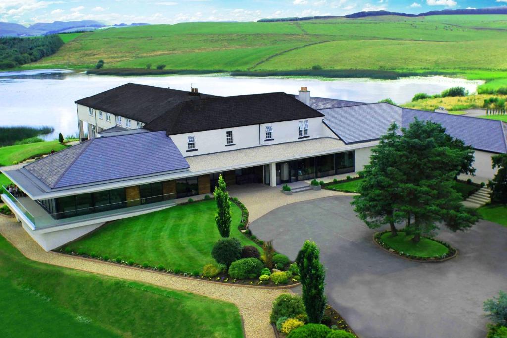 an aerial view of a large house with a driveway at Lochside House Hotel & Spa in New Cumnock
