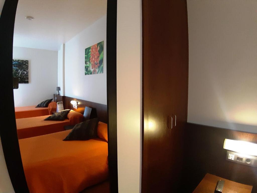 Postel nebo postele na pokoji v ubytování Hostal Nirvana