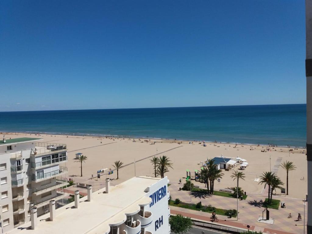 a view of the beach from the balcony of a building at Mi Gaviota, Primera Línea VT-49181-V in Gandía