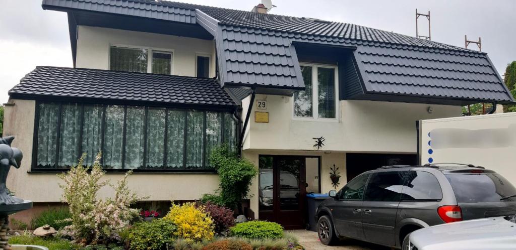 a house with a car parked in front of it at Pas Elvyrą in Palanga