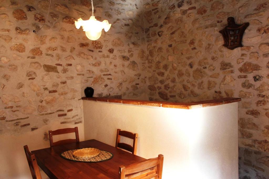 a dining room with a table and chairs and a lamp at Apartments Parco d'Abruzzo in Bisegna