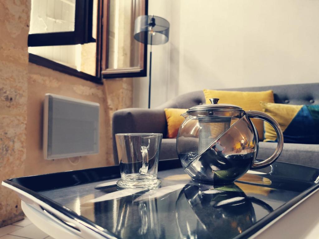a glass coffee table with a fish bowl on it at Appartement de charme, au cœur d&#39;Auch, 4 pers in Auch