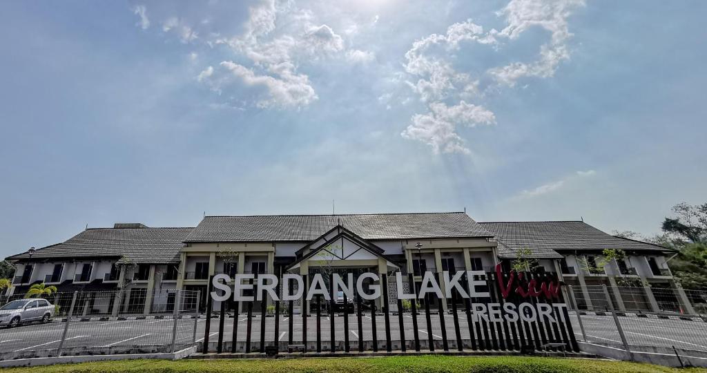 a building with a fence in front of it at SERDANG LAKE VIEW RESORT in Sungai Kechil