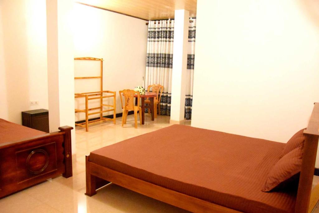 Postel nebo postele na pokoji v ubytování Wingate Hotel Wilgamuwa