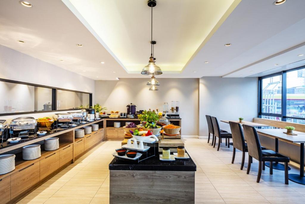 A self-service breakfast room with buffet counters, a central island and window seating.