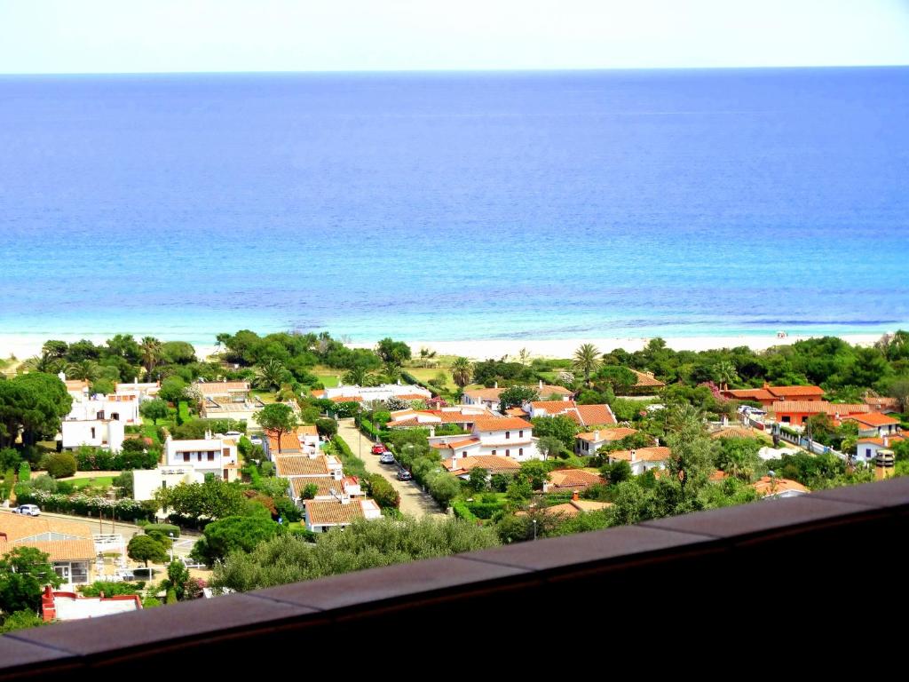 a view of a town with the ocean in the background at Villetta Best Vacation Ever, Costa Rei in Costa Rei