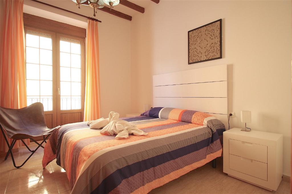 un dormitorio con una cama con un animal de peluche en Apartamento Cop City Centre by costablancarent, en Denia