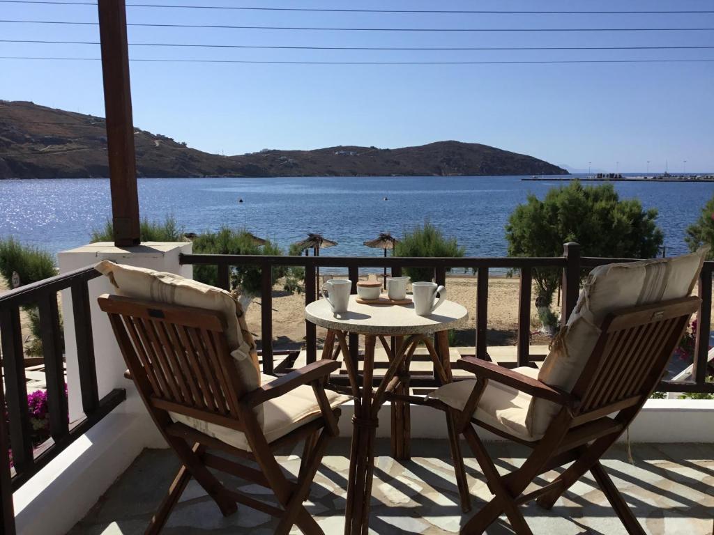 a table and chairs on a balcony with a view of the water at Asteri Hotel in Livadi