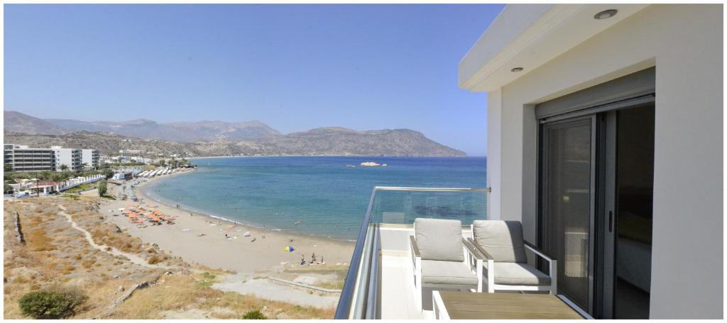 a balcony with a view of a beach and the ocean at Potideon Bay Luxury Apartments in Karpathos