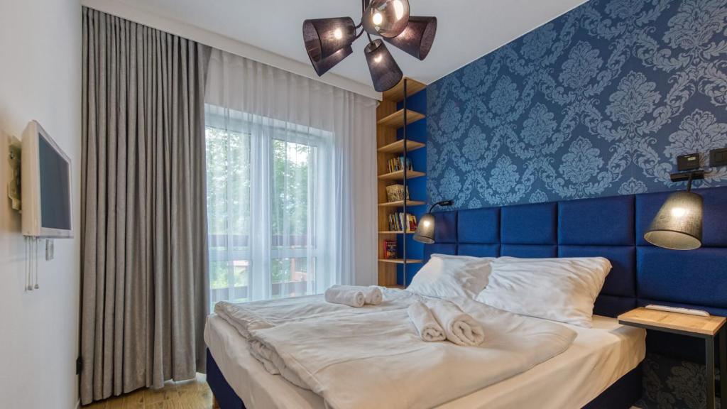 Posteľ alebo postele v izbe v ubytovaní Apartament 41 Holiday Mountain Residence - 5D Apartamenty