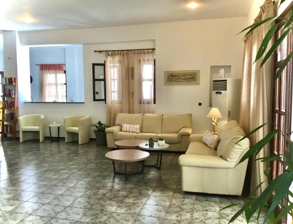 a living room with couches and a table at Asteri Hotel in Livadi