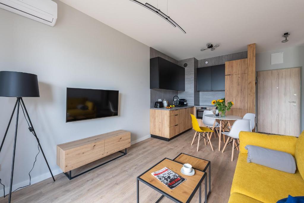 Televízia a/alebo spoločenská miestnosť v ubytovaní MODUO Serviced Apartments