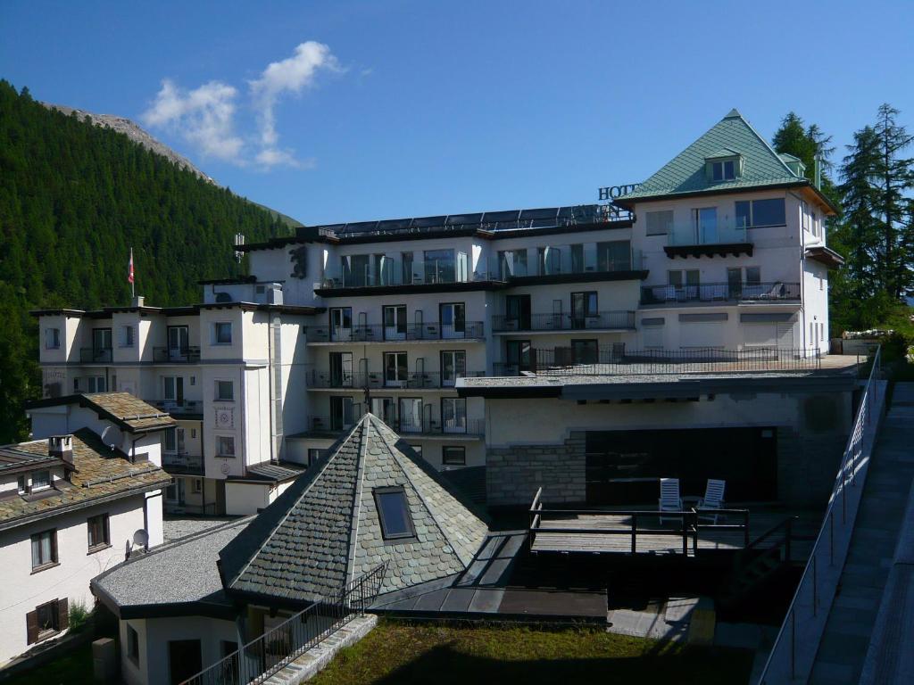 a large white building in the middle of a city at Hotel Bären in St. Moritz