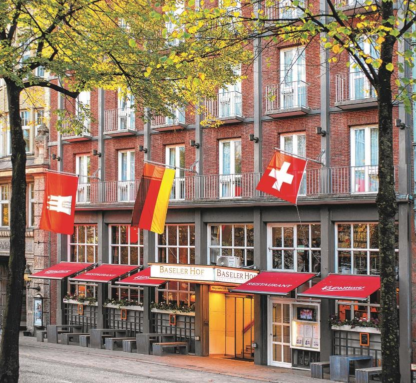 a building with flags in front of it at Hotel Baseler Hof in Hamburg