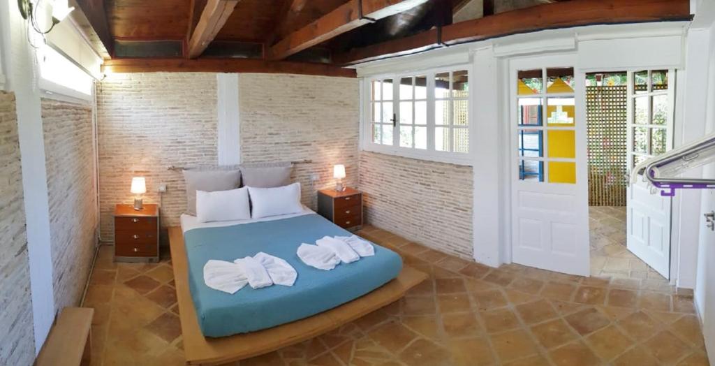 a bedroom with a bed with two towels on it at Anemona Apartments and Studios in Vasilikos