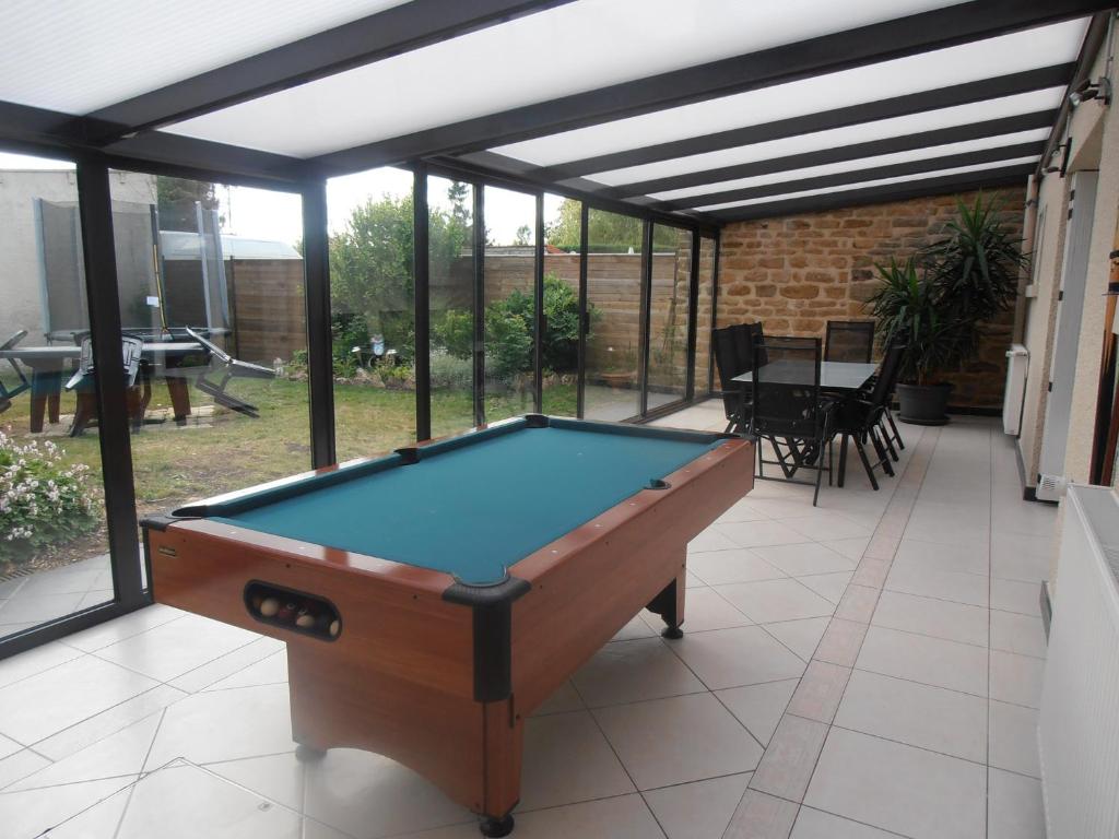 a pool table in the middle of a patio at Gîte des Corneilles in Maubert-Fontaine