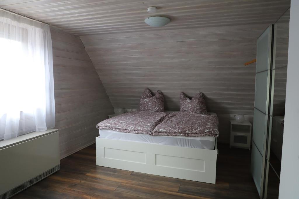 a small bedroom with a bed in a attic at Ferienhaus Irene in Friedrichshafen