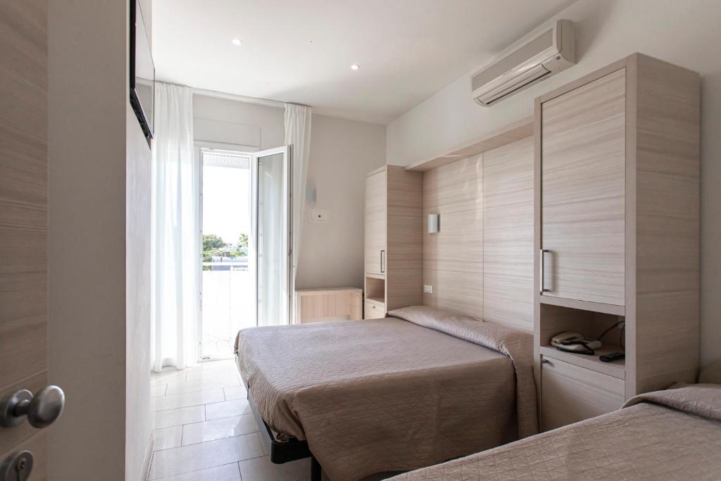 Postel nebo postele na pokoji v ubytování Hotel Primiana
