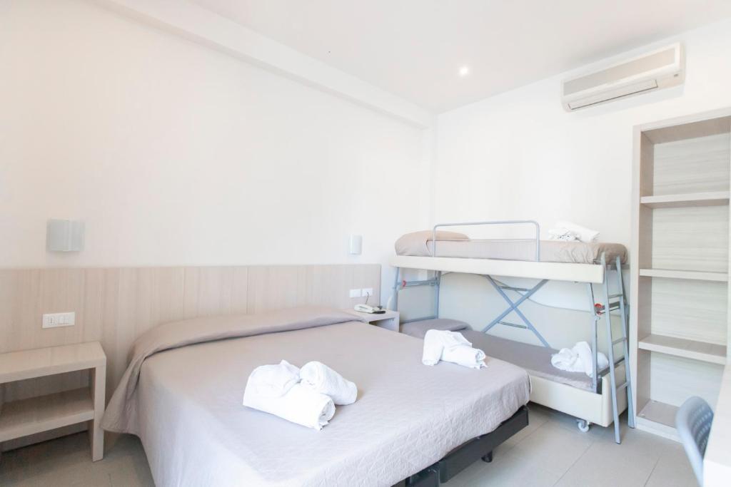 Postel nebo postele na pokoji v ubytování Hotel Primiana