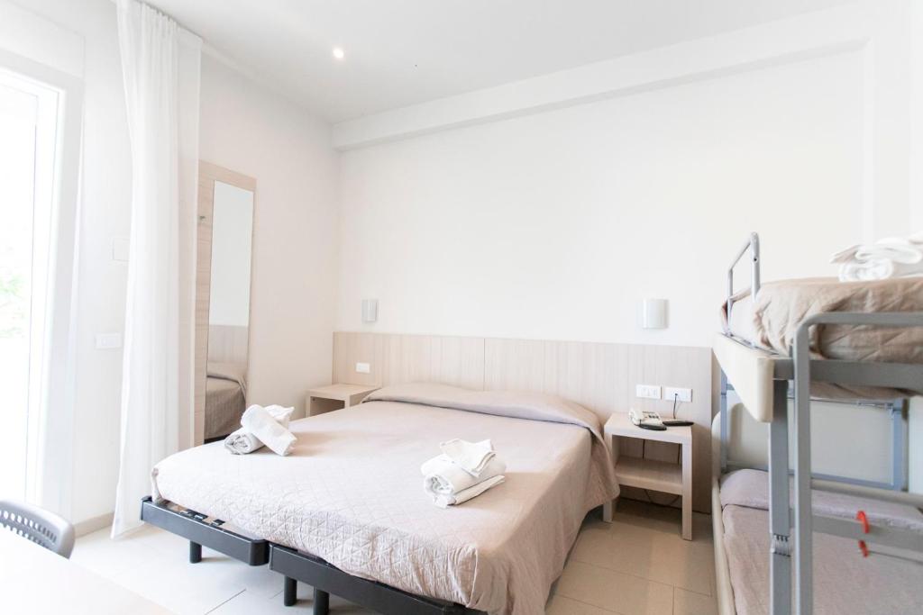 Postel nebo postele na pokoji v ubytování Hotel Primiana