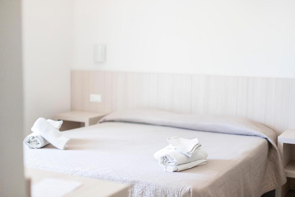 Postel nebo postele na pokoji v ubytování Hotel Primiana