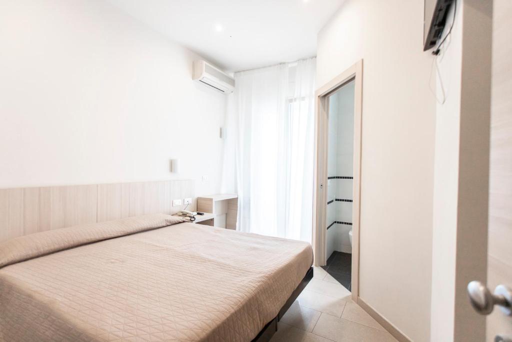 Postel nebo postele na pokoji v ubytování Hotel Primiana