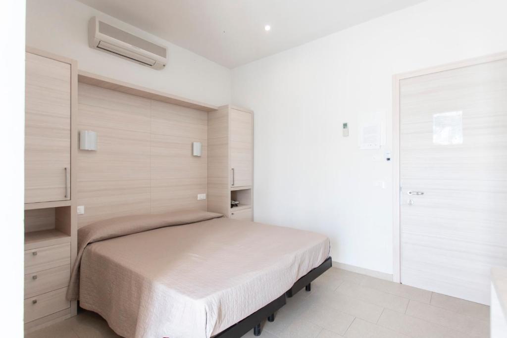 Postel nebo postele na pokoji v ubytování Hotel Primiana