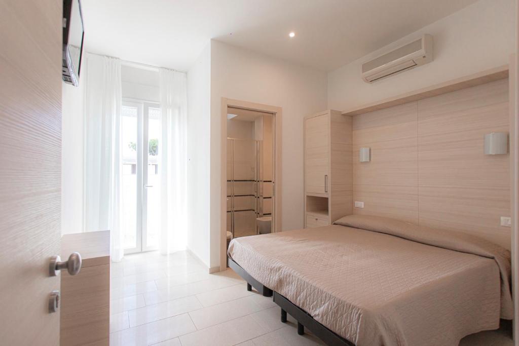 Postel nebo postele na pokoji v ubytování Hotel Primiana